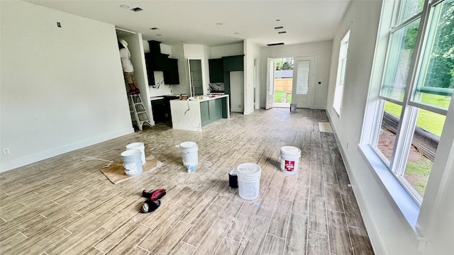 2418 Centennial St, Liberty, TX 77575 - unfurnished living room with light wood-style floors and baseboards