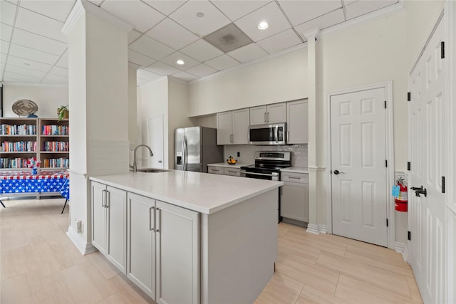 1111 Bering Dr Unit 1001, Houston, TX 77057 - kitchen featuring stainless steel appliances, gray cabinetry, a paneled ceiling, light countertops, and a peninsula