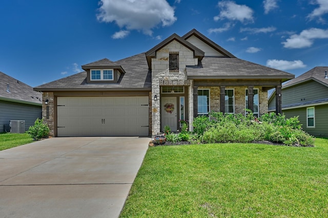 1009 Old Vine, Brenham, TX 77833 - view of front of home with a front yard, concrete driveway, an attached garage, and stone siding