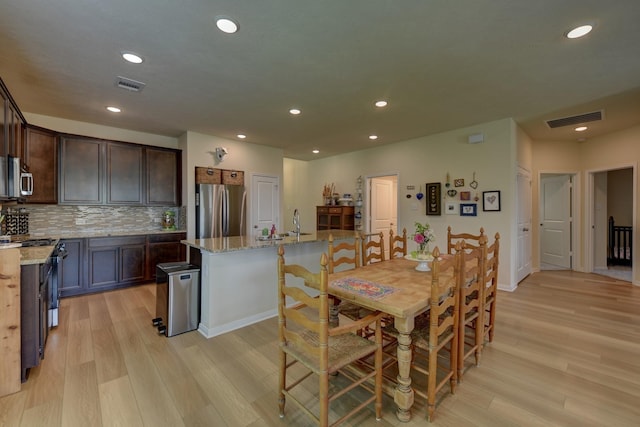 1009 Old Vine, Brenham, TX 77833 - dining area featuring light wood-type flooring and recessed lighting