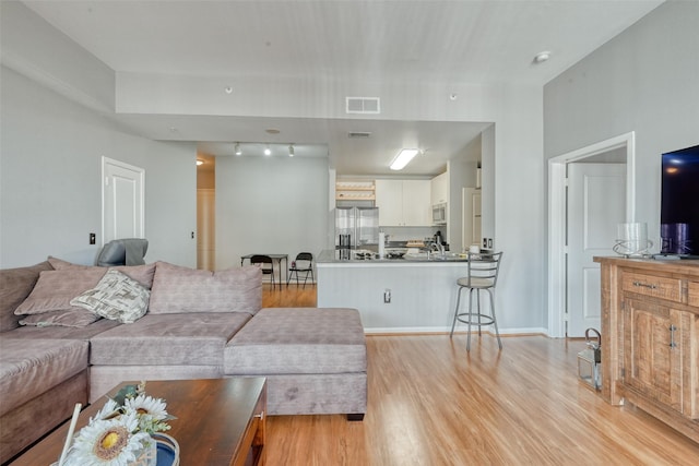 3505 Sage Rd Unit 1206, Houston, TX 77056 - living room with light wood-type flooring and rail lighting