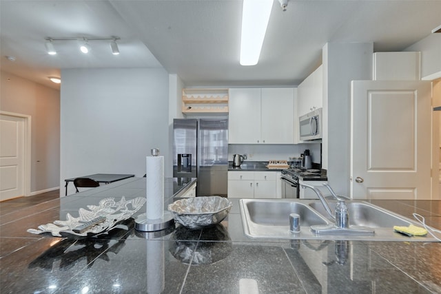 3505 Sage Rd Unit 1206, Houston, TX 77056 - kitchen with appliances with stainless steel finishes, white cabinets, dark countertops, and open shelves