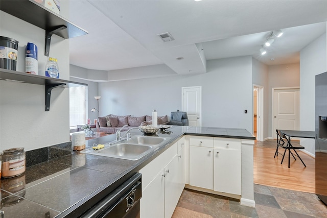 3505 Sage Rd Unit 1206, Houston, TX 77056 - kitchen featuring white cabinetry, a peninsula, open floor plan, dishwasher, and track lighting