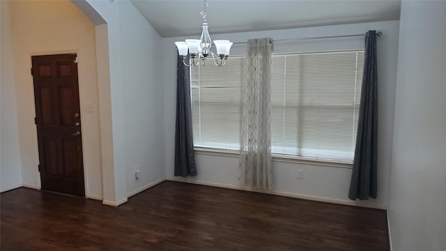11718 Emerald Wood Dr, Houston, TX 77070 - unfurnished dining area with arched walkways, dark wood-type flooring, and a chandelier