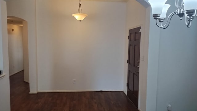 11718 Emerald Wood Dr, Houston, TX 77070 - corridor featuring arched walkways, a chandelier, and dark wood-type flooring
