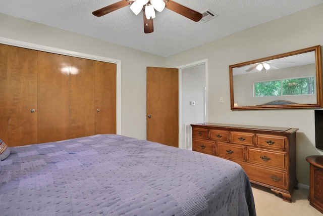 63 Harbour Row Dr, Coldspring, TX 77331 - bedroom with light carpet, a textured ceiling, a ceiling fan, and a closet