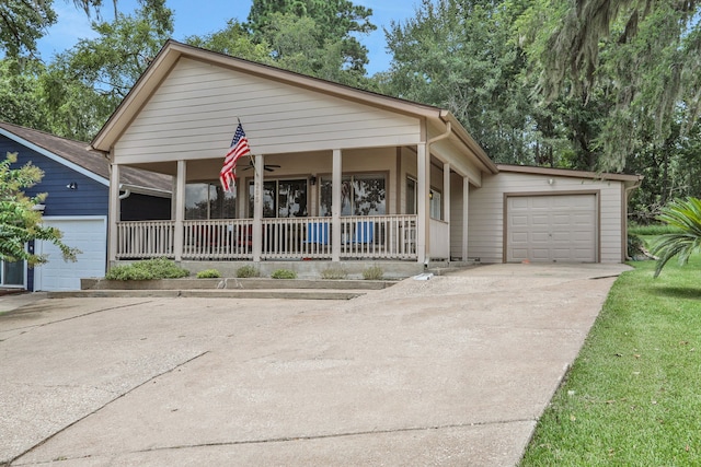 63 Harbour Row Dr, Coldspring, TX 77331 - view of front of property featuring a garage, a porch, and concrete driveway
