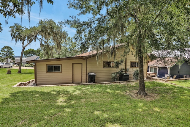 63 Harbour Row Dr, Coldspring, TX 77331 - back of house featuring a lawn