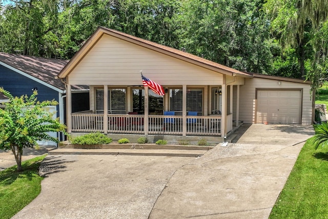 63 Harbour Row Dr, Coldspring, TX 77331 - view of front of property featuring a porch, concrete driveway, and an attached garage