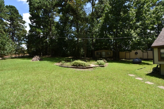 191 Harvey Bryant Rd, Coldspring, TX 77331 - view of green lawn featuring a storage unit