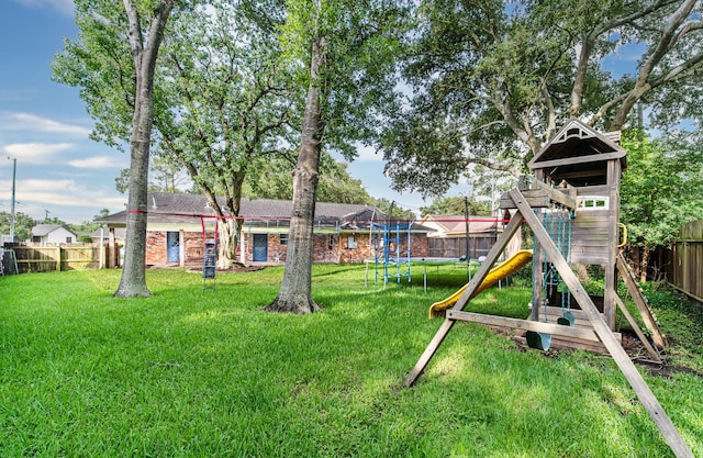 3405 Randall St, Pearland, TX 77581 - fenced backyard with a trampoline and a playground