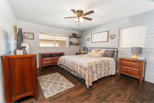 3405 Randall St, Pearland, TX 77581 - bedroom with wood finished floors, wooden walls, a ceiling fan, and a textured ceiling