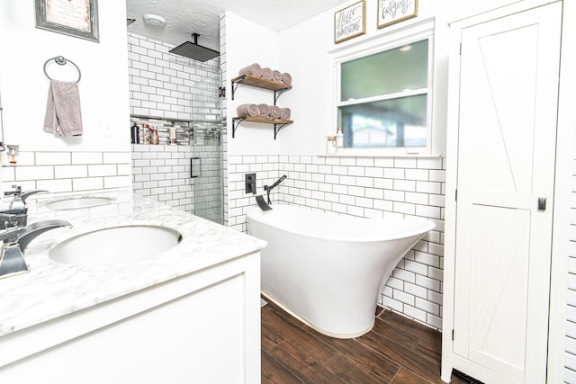 3405 Randall St, Pearland, TX 77581 - full bath featuring tile walls, double vanity, wood finished floors, tiled shower, and a freestanding tub
