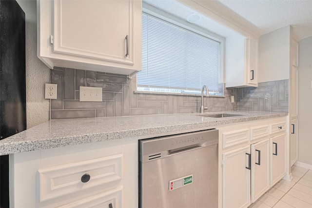 6822 Stonewater, Houston, TX 77084 - kitchen featuring dishwasher, tasteful backsplash, white cabinetry, light tile patterned floors, and a textured ceiling