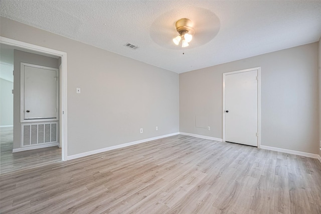6822 Stonewater, Houston, TX 77084 - unfurnished room with a ceiling fan, light wood finished floors, and a textured ceiling