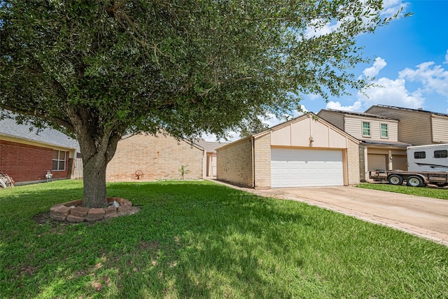 6822 Stonewater, Houston, TX 77084 - view of front of property featuring brick siding, a front lawn, driveway, a garage, and board and batten siding