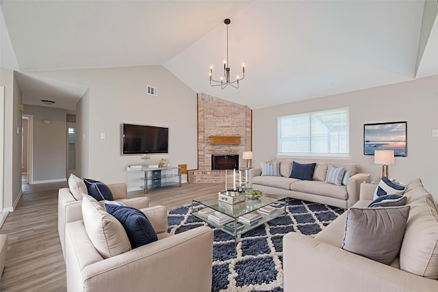 6822 Stonewater, Houston, TX 77084 - living room featuring a chandelier, light wood-type flooring, a stone fireplace, and high vaulted ceiling