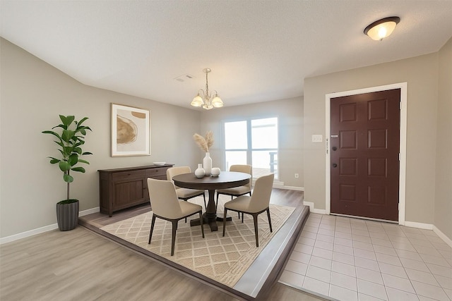 6822 Stonewater, Houston, TX 77084 - dining area featuring a chandelier and light wood-style floors