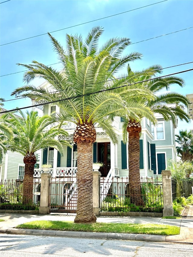 2113 Ball, Galveston, TX 77550 - view of front of home with a fenced front yard, covered porch, and a gate