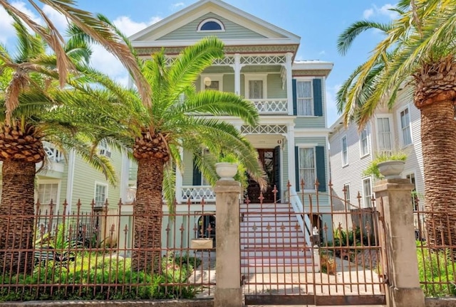 2113 Ball, Galveston, TX 77550 - view of front of home featuring stairs, a porch, and a balcony