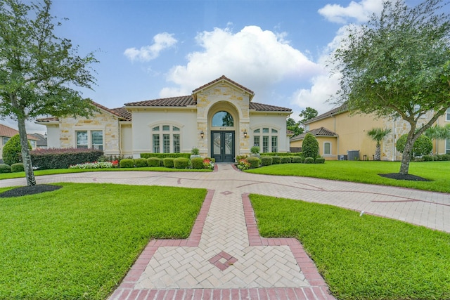 9503 Martha Springs Dr, Houston, TX 77070 - mediterranean / spanish house featuring a front lawn, french doors, stone siding, stucco siding, and a tile roof