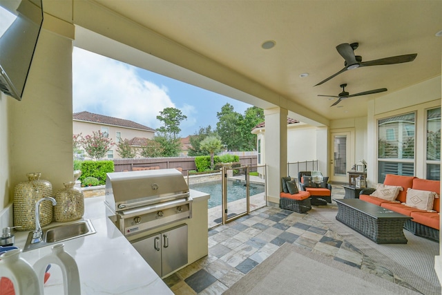 9503 Martha Springs Dr, Houston, TX 77070 - fenced backyard with an outdoor hangout area, a patio area, ceiling fan, and exterior kitchen