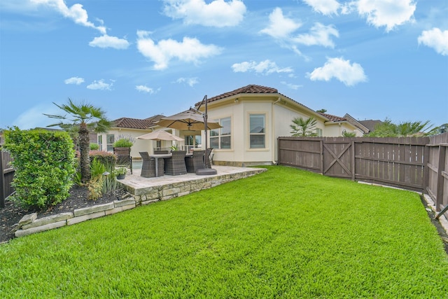 9503 Martha Springs Dr, Houston, TX 77070 - back of property featuring stucco siding, a patio area, a fenced backyard, and a tiled roof