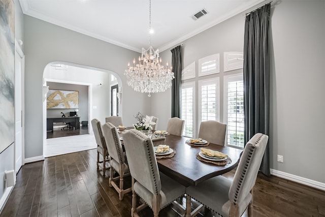 9503 Martha Springs Dr, Houston, TX 77070 - dining space with arched walkways, dark wood-style floors, ornamental molding, and a chandelier