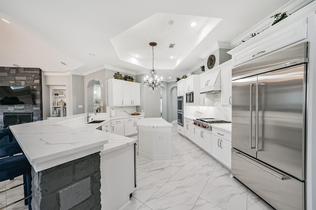 9503 Martha Springs Dr, Houston, TX 77070 - kitchen featuring stainless steel appliances, arched walkways, a chandelier, recessed lighting, and white cabinetry