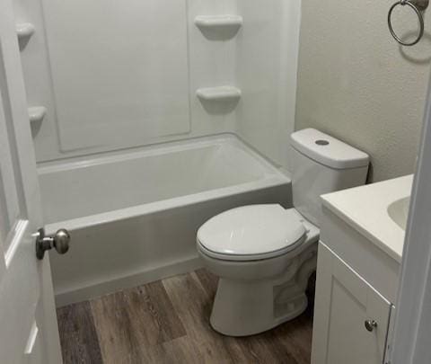 2308 13th Ave N, Texas City, TX 77590 - bathroom with wood finished floors, vanity, and bathing tub / shower combination