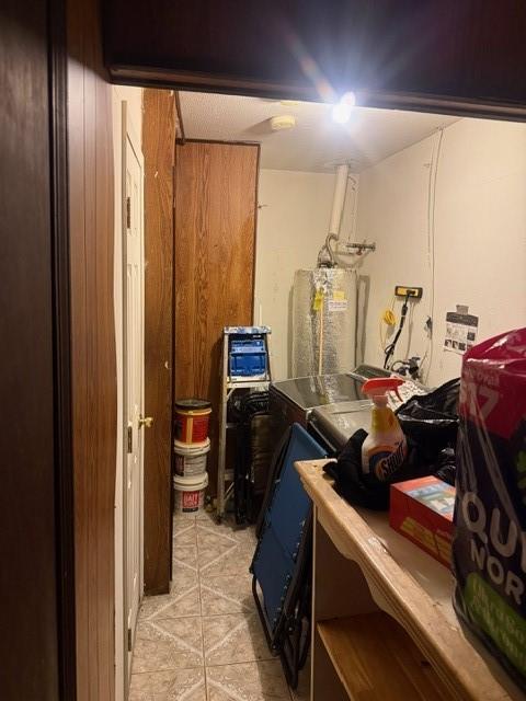 4514 Kress St, Houston, TX 77026 - below grade area featuring water heater and light tile patterned flooring