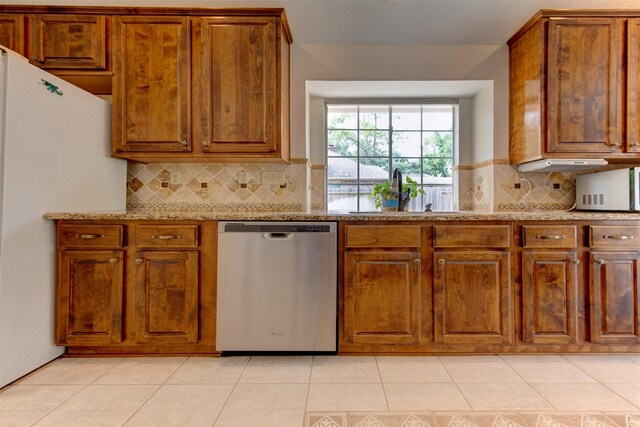 3910 Sand Myrtle Dr, Houston, TX 77059 - kitchen featuring white appliances, brown cabinets, light tile patterned flooring, backsplash, and light stone countertops