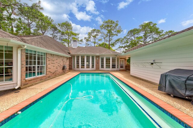 3910 Sand Myrtle Dr, Houston, TX 77059 - view of swimming pool with area for grilling, a patio area, and french doors