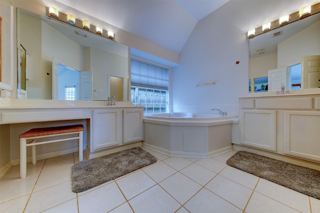 3910 Sand Myrtle Dr, Houston, TX 77059 - bathroom with lofted ceiling, a bath, tile patterned flooring, and two vanities