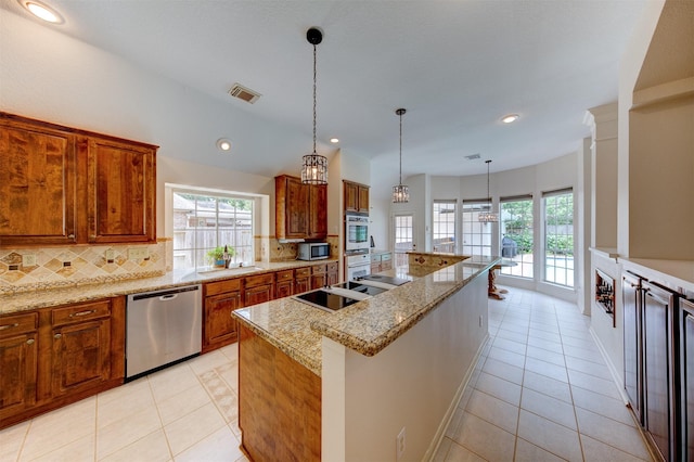 3910 Sand Myrtle Dr, Houston, TX 77059 - kitchen featuring stainless steel appliances, healthy amount of natural light, brown cabinetry, tasteful backsplash, and recessed lighting