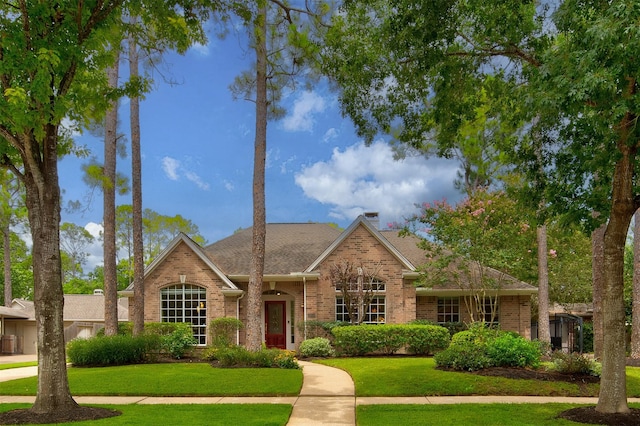 3910 Sand Myrtle Dr, Houston, TX 77059 - view of front of home with brick siding, a front lawn, and a chimney