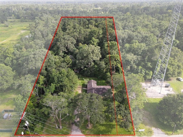 26334 Fm 2090th Rd, Splendora, TX 77372 - aerial view of property and surrounding area featuring a forest and property parcel outlined