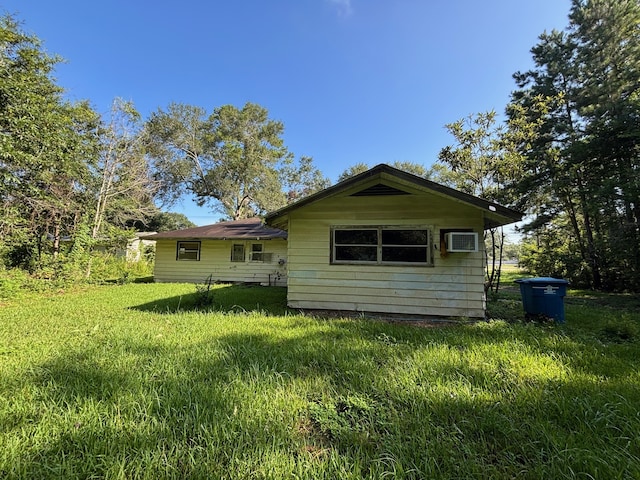 26334 Fm 2090th Rd, Splendora, TX 77372 - rear view of house with an AC wall unit and a yard