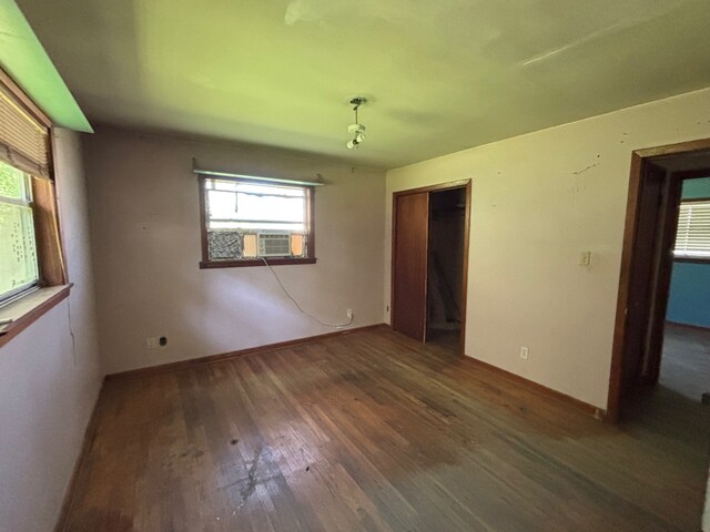 26334 Fm 2090th Rd, Splendora, TX 77372 - unfurnished bedroom featuring wood finished floors, cooling unit, and a closet