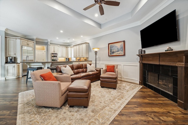 59 N Berryline Cir, Spring, TX 77381 - living room with a ceiling fan, a fireplace, ornamental molding, dark wood-type flooring, and recessed lighting