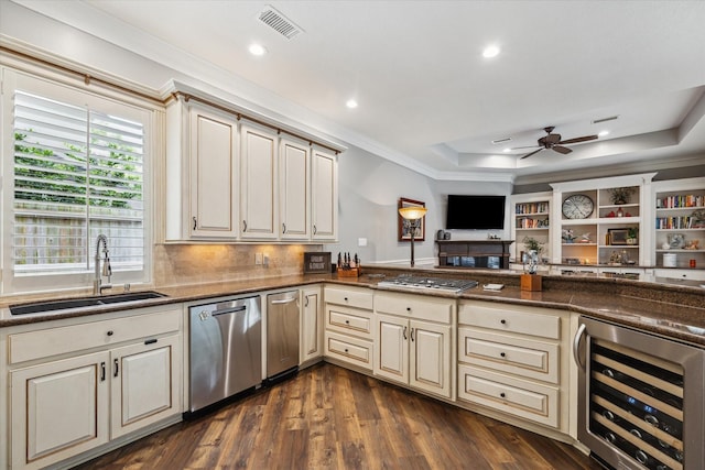 59 N Berryline Cir, Spring, TX 77381 - kitchen featuring beverage cooler, cream cabinets, appliances with stainless steel finishes, a raised ceiling, and a ceiling fan