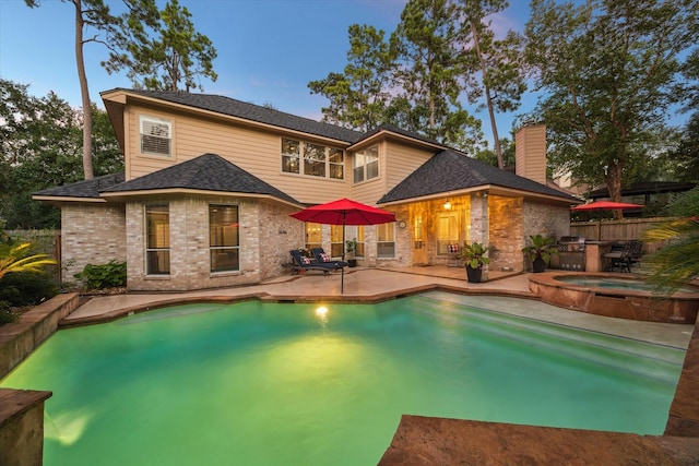 59 N Berryline Cir, Spring, TX 77381 - back of property featuring a patio area, brick siding, a chimney, and a shingled roof