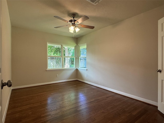 6202 Simsdale St, Houston, TX 77087 - empty room featuring dark wood-style flooring, ceiling fan, and a textured ceiling