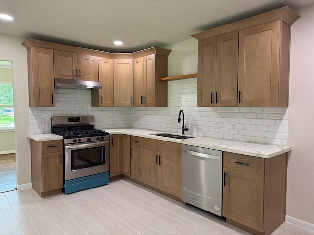 6202 Simsdale St, Houston, TX 77087 - kitchen with stainless steel appliances, under cabinet range hood, backsplash, and recessed lighting