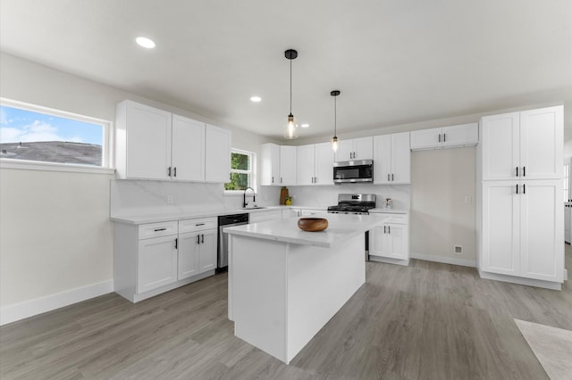 200 Burnett Dr, Baytown, TX 77520 - kitchen featuring appliances with stainless steel finishes, recessed lighting, white cabinetry, light countertops, and light wood-type flooring