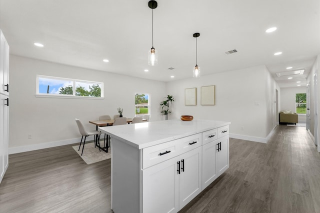 200 Burnett Dr, Baytown, TX 77520 - kitchen featuring light countertops, a kitchen island, healthy amount of natural light, white cabinets, and recessed lighting