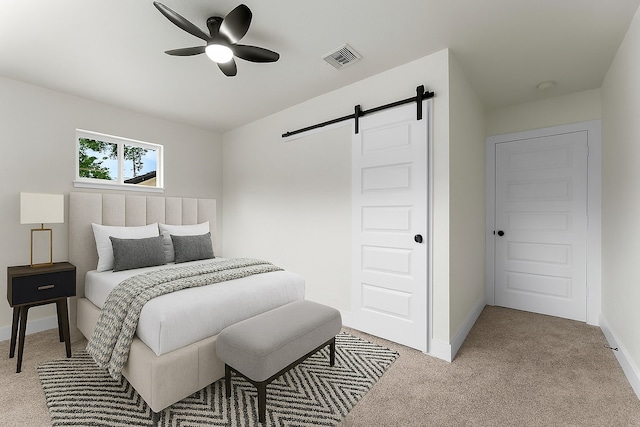 200 Burnett Dr, Baytown, TX 77520 - bedroom with a barn door, light carpet, and a ceiling fan