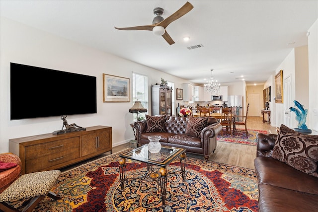 23502 Glenbuck St, Spring, TX 77373 - living room featuring a chandelier, a ceiling fan, light wood-style flooring, and recessed lighting