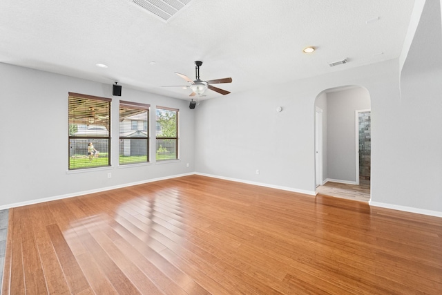 18203 Park Sage Ct, Cypress, TX 77433 - unfurnished room with arched walkways, a ceiling fan, light wood finished floors, and recessed lighting
