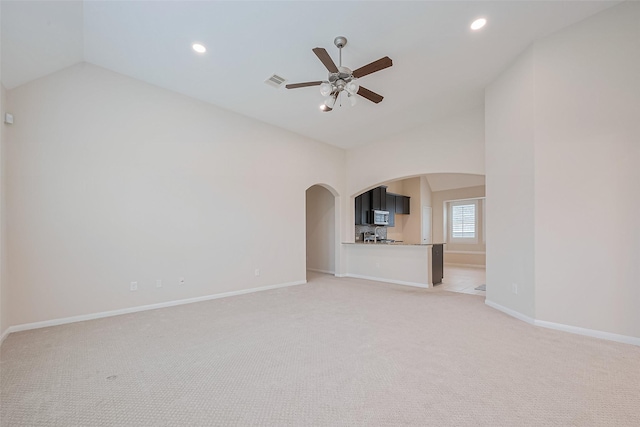 19911 Whistle Creek Ln, Cypress, TX 77433 - unfurnished living room featuring arched walkways, lofted ceiling, light carpet, recessed lighting, and ceiling fan